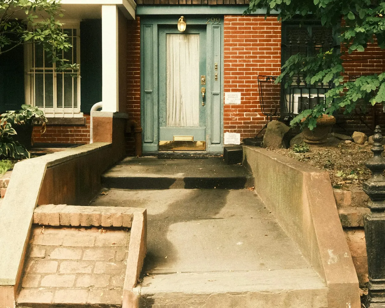 Front entry of a brick residential property in daylight